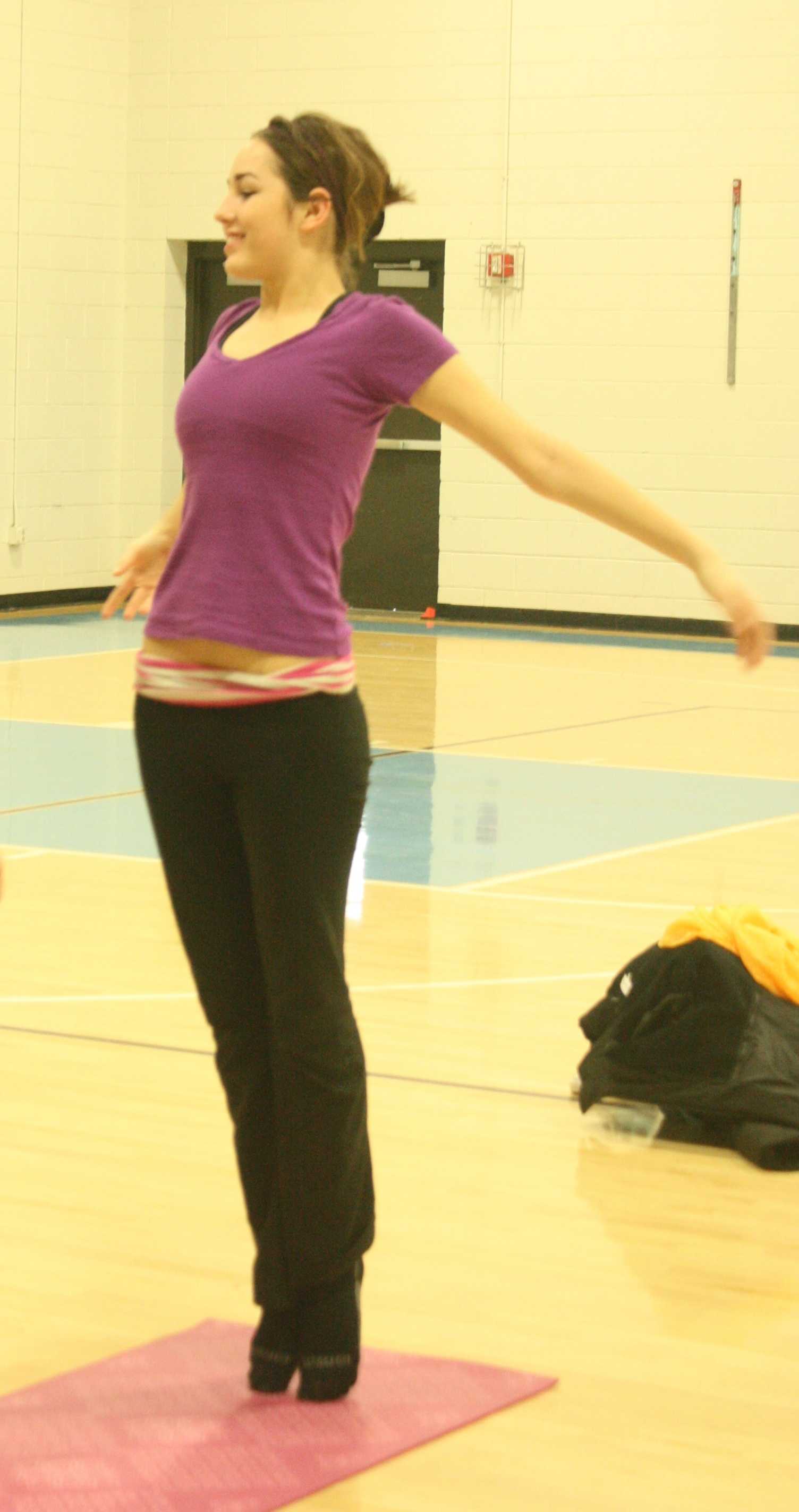 Junior Hilli Alden practices yoga with Women of West (WOW) on March 3 in the north gym before school.