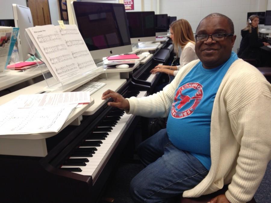 Choir and Piano teacher Eric Anthony helps one of his Piano 2 students. 