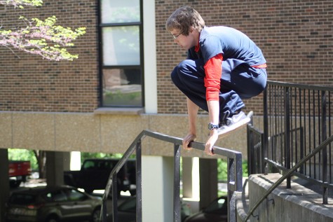 Freshman Joe Butler hurdles over a rail while practicing his parkour stunts.