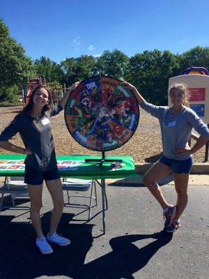 Seniors Grace Gwin and Kaitlyn Kastberg help set up games and help run them at the Green Trails Carnival on September 19th for Community Outreach at West hours. 
