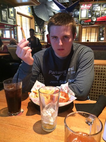 Holding up a crinkle-cut fry, senior Daniel Roseman regrets his decision to go with the traditional fry choice.