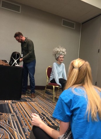 Sophomore Kennedy Brown tries on the Ursula wig in a workshop at Thescon. 