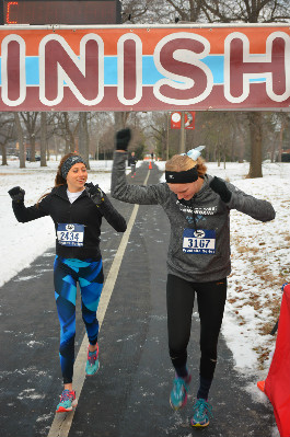Osborne and Butler cross the finish line of the Frostbite Half Marathon