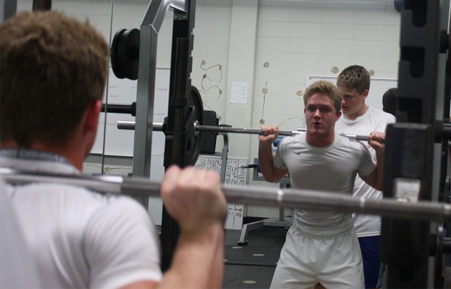 Sophomore Judson Martin stares straight ahead as he focuses on lifting  weights during longhorn power.