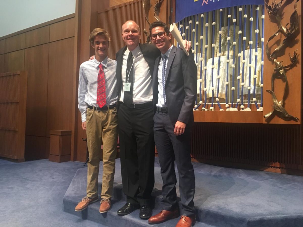 Freshman Joe Rosenberg, Principal Jeremy Mitchell and junior Zach Poscover attend the 9 a.m. Rosh Hashanah service at United Hebrew on Sept. 21. 
