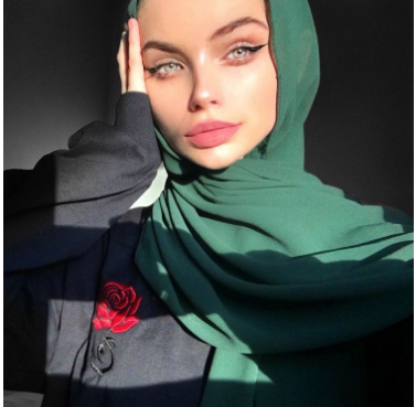 Senior Bama Nanić poses with her colored ttdeye contacts and green diamante scarves hijab. In 20 hours, the picture gained 3,460 likes. “Middle school was when I fell in love with makeup, and in high school, I just really felt like stepping my game up,” Nanić said.
