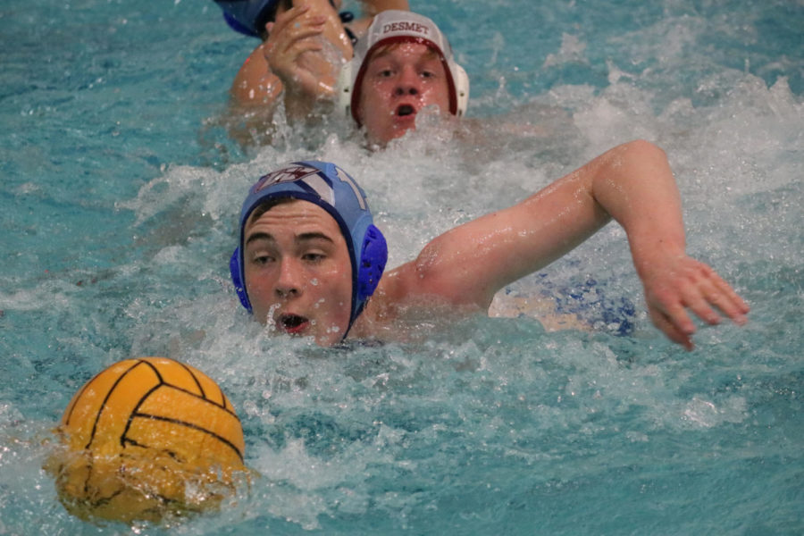 Junior Alex Nozka dives for the ball after a fumble. Over the past eight years, the water polo team has advanced to the state semifinals six times. “We all work really hard to get where we are,” Nozka said. “We all push each other in practice and we all find pride in our work.”