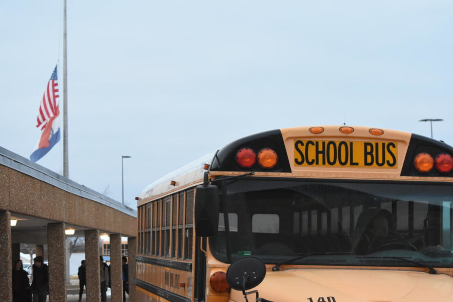 A Parkway school bus waits outside the buildings front entrance.