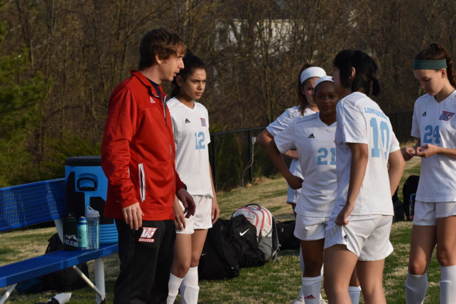 JV soccer coach Darren Rahe informs his players what position they will be playing. Rahe taught the girls about their role on and off the field. ¨If you approach practice each and everyday to be the best that you can be, you can use that same mental focus for anything that you do in life,¨ Rahe said.
