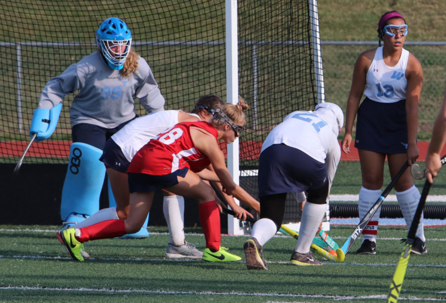 During a game against the Lindbergh Flyers, sophomore Karen Trevor-Roberts guards her goal. “I do everything to make sure the ball doesn’t get into the goal, even during practice when a lot of balls are being shot against me,” Trevor-Roberts said. “[Field hockey] gives you a family. It teaches me teamwork and even helps with social skills. It also teaches me how to balance school and sports.” 