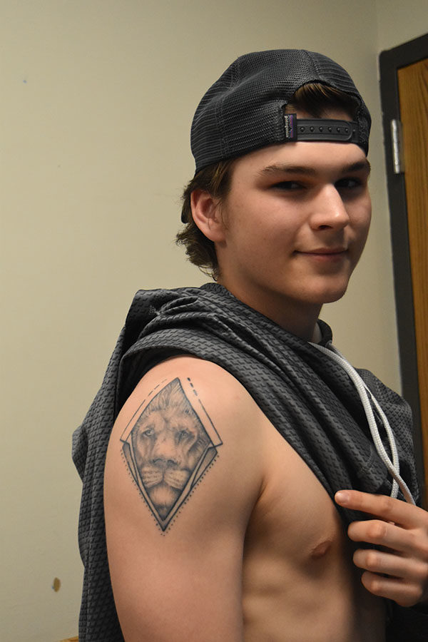Displaying a tattoo of a lion, junior Joel Ottensmeyer says that his tattoo was designed for him by his sister. Despite some disagreement on his decision to get a tattoo at a young age, Ottensmeyer continued his family’s tradition of getting tattoos because it was something that he cared about a lot. “[My tattoo] means [being] strong, prideful and protecting the people that you love,” Ottensmeyer said.