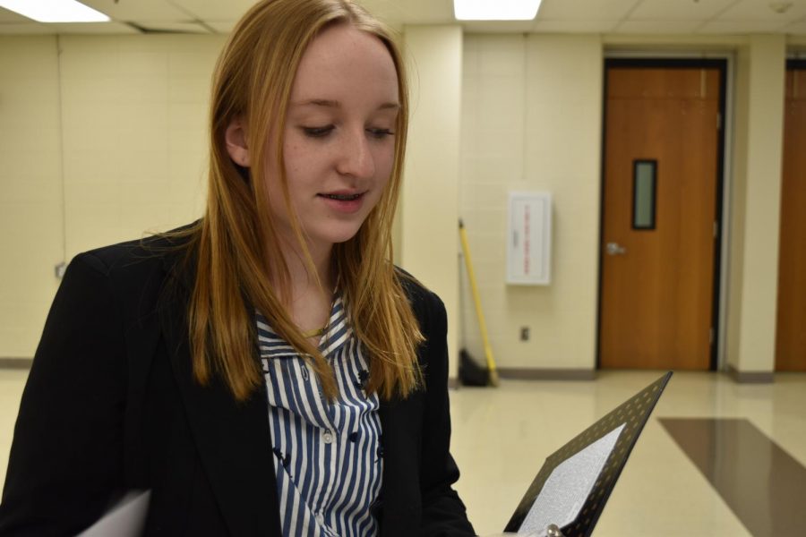 Junior Laura Young refines her speech after receiving feedback from teammates. Young and her debate partner, junior Zoey Womick (not pictured), placed second in the Greater St. Louis Conference in Public Forum Debate for the 2018-19 season. “Being a girl in debate is sometimes intimidating because when you go up against really good teams that are two males or even just one guy, they oftentimes have more of a reputation than the really excellent all-girl teams do,” Young said. “A lot of events are also male-dominated, which is also extremely intimidating because they come off as very charismatic and have so much more of a reputation that its just really scary to go up against them.”