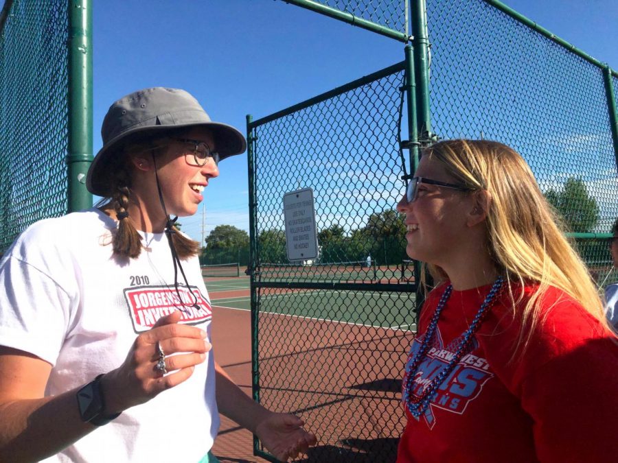 JV tennis coach Audra Hartwell gives sophomore Betsy Weaver parade line up details before the Homecoming parade begins. Hartwell made a point to her players about having fun while also competing at a high level. “ I want tennis to be the best part of their day because it keeps them coming back,” Hartwell said. “I want them excited to come to practice or a match.”
