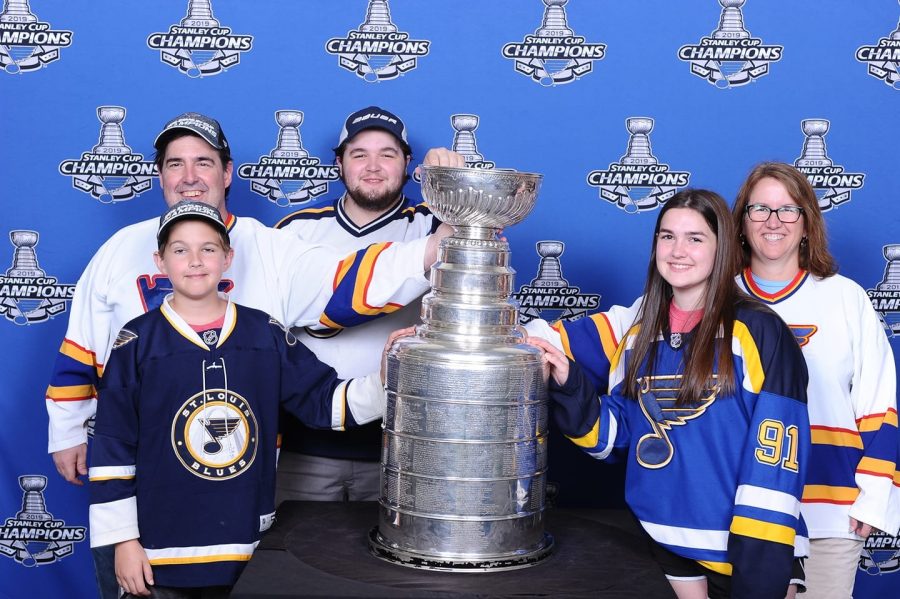 Senior Maggie Brawley smiles with her family, experiencing the Stanley Cup for the third time this year at an event for season ticket holders. Brawley intends to become a professional hockey player. “I played hockey, and as a kid, I really looked up to them [the Blues]. It was a really, really cool experience,” Brawley said. 