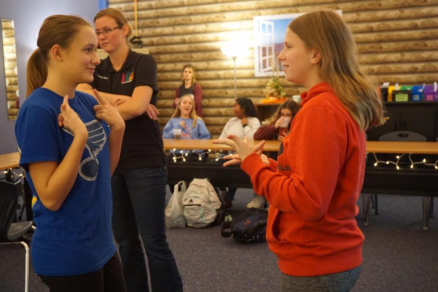 Freshmen Elle Rotter and Sami Eveland have a conversation during ASL club’s Friendsgiving meeting. The club had pizza and soda while chatting and playing games. “I enjoy visiting ASL club and talking to my friends,” Eveland said. “I’ve met some cool new people who are interested in ASL just like me.”