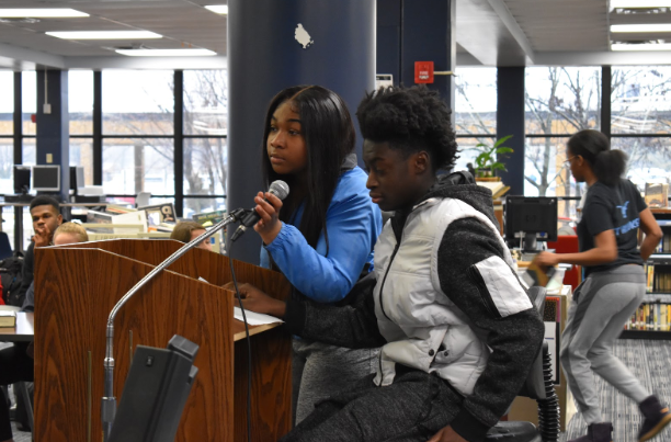 Speaking into the microphone, senior Taylor Fisher reads a poem written by the African American Literature class. Fisher emphasized her cultural pride. “We love our skin, and we love what we do. We’re very powerful,” Fisher said. 
