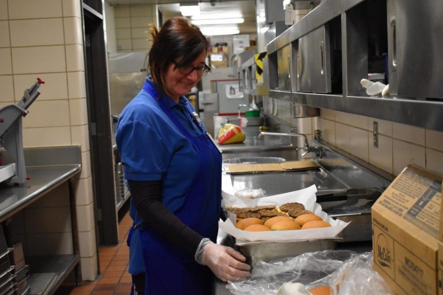 Preparing for school lunch, cafeteria employee Edina Husic lays out burger buns. Most leftover foods are composted at the end of the day, unless they can be served again. “It seems like we do waste a lot of food. Overall the whole picture for school food service across the nation’s waste . . . it’s some astronomical number,” Food Service Regional Manager Kenny Witte said. “We actually are continuously improving and forecasting and are trying to make our menus more appealing and getting kids to eat more of the foods that were offering, so that way we have less waste. Its improving.”