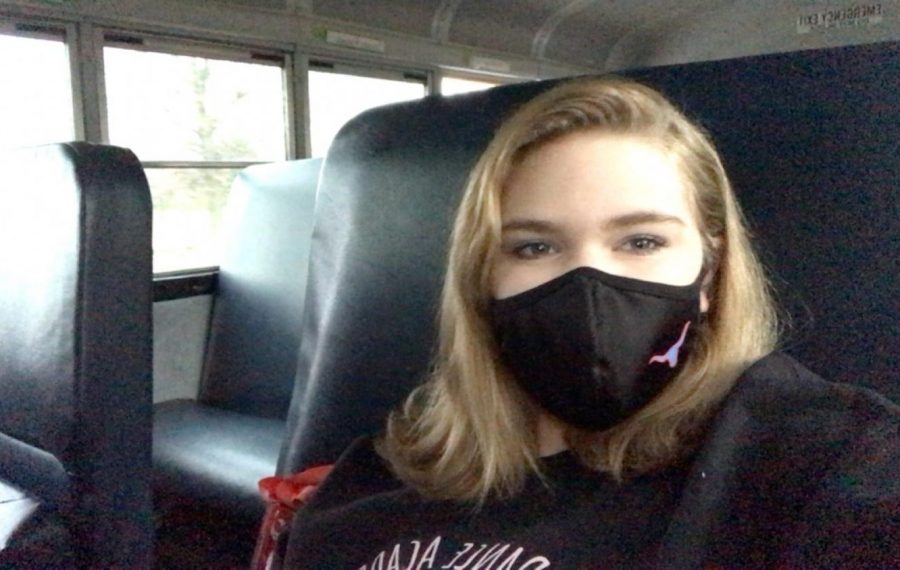 Freshman Paige Schnarr, equipped with her Longhorns mask, documents her bus ride to school. Bus riders sat one person per row and alternated between the left and right seats to maintain distance. “I was doing well with online learning, but for me, if I’m not in the classroom, then I feel like I don’t get as much done,” Schnarr said.