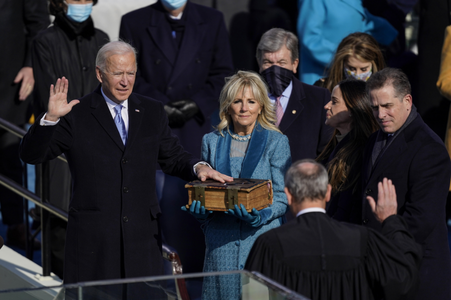 President Joe Biden takes the oath of office from Supreme Court Chief Justice John Roberts as his wife, first lady Jill Biden, stands next to him during the 59th presidential inauguration. 