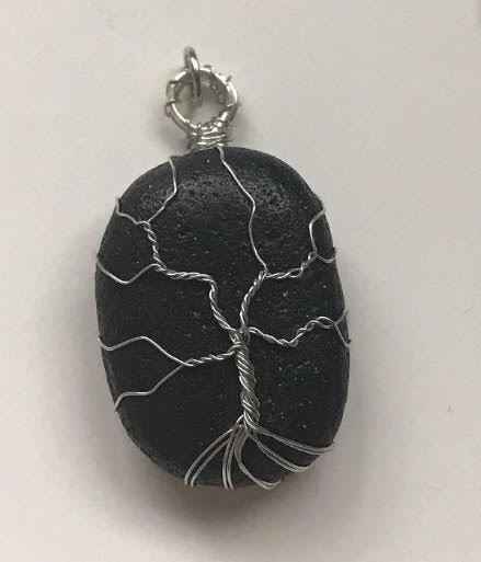 The Tree of Life, Addie Gleasons favorite design, displayed on a fossilized fishbone in silver wire. 