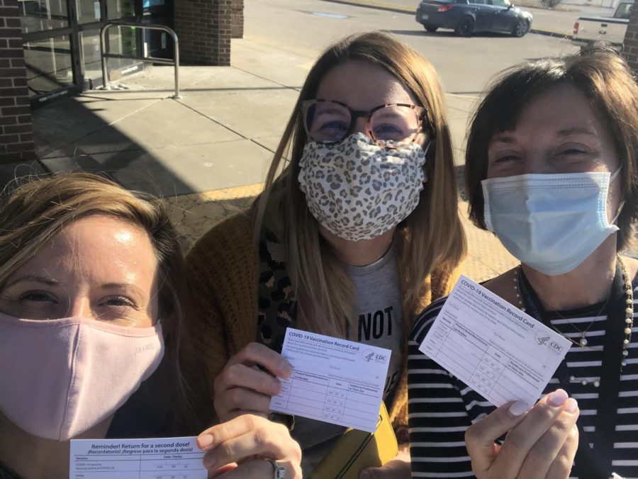Taking a selfie with fellow teachers, librarian Lauren Reusch displays her vaccination card. Reusch travelled with English teachers Erin Fluchel and Shannan Cremeens to Illinois to be vaccinated. “I am most excited to go out to eat in an actual restaurant with my husband,” Reusch said. 