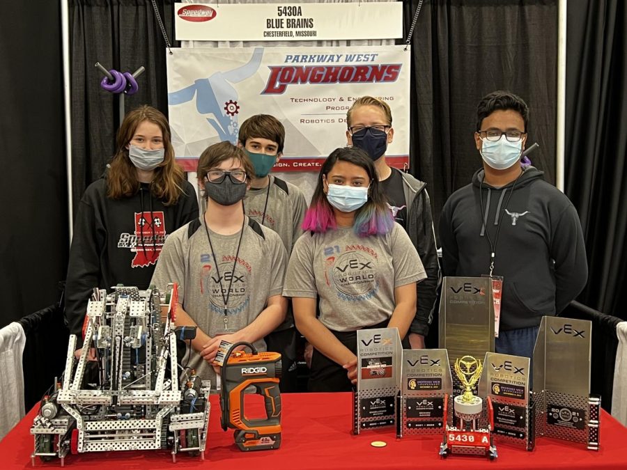 The Blue Brains team members juniors Katherine Hanses, Joseph Britt, Isaac Porter and Anushka Dharmasanam and seniors David Meisinger and Rick Biswas pose in front of their robot and awards at the Speedway signature event in Indianapolis. The awards include their trophies from smaller competitions and World 2021, as well as a small trophy gifted to the team for their performance by robotics sponsor Chris Donaldson. “The trophy was for just being a good team, because this was our first big signature event outside of the virtual ones we did last year,” Hanses said. “[At this competition], we had six matches on the first day, and we won five. We got knocked out in the quarterfinals.”