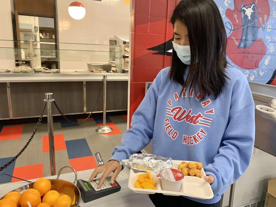 Senior Marissa Liu checks out her lunch in the school cafeteria. Liu has purchased school lunches since elementary school, when she qualified for reduced lunch at Henry Elementary School. “I appreciate the idea that lunch is free, especially for public school kids,” Liu said. “For me now though, it’s a matter of how much time and energy I have in the morning that determines whether or not I buy lunch,” Liu said.