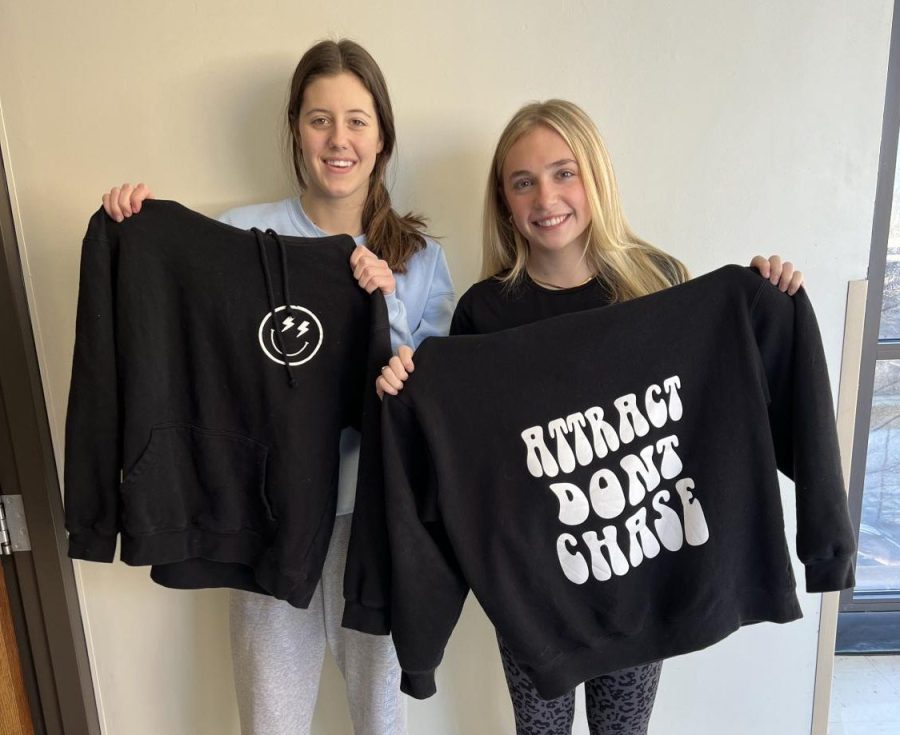 Posing for a picture, seniors Claire Folkins and Lauren Beach wear their handmade hoodies from their small business @sundaymorning_stl. Folkins and Beach knew their target market and saw the opportunities from starting their own business. “We want [our customers] to feel like they are living like their Pinterest board,” Folkins said. “We found a way to make the sweatshirts many teens want, affordable and customizable which is different from a professional online shop.”