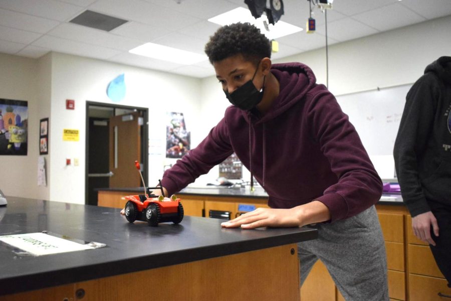During an experiment in his honors Force and Motion class, freshman Jacksen McNeal pushes the car across the table. Physics teacher Amy Van Matre-Woodward taught how to calculate velocity and used toy cars as practice for students. “I enjoyed this activity because it was a [creative] way to practice finding velocity. I [also] just liked playing with the cars,” McNeal said.