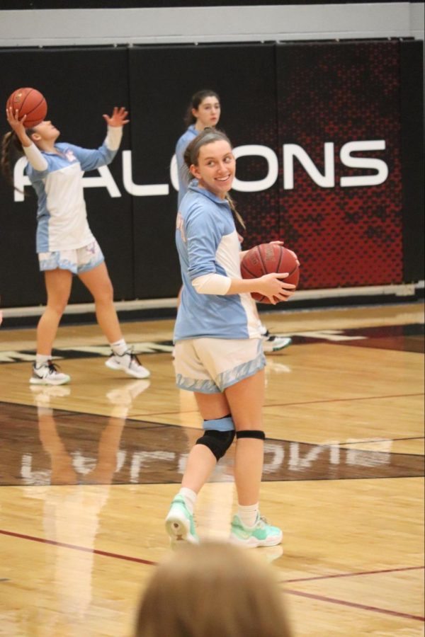 Back on the court, senior Abbie Zensen warms up to play in the first game of the Summit Holiday Hoops tournament. Zensen was injured in May, leaving her unable to participate in sports. “I was a little worried at first because I wasnt sure what it was going to be like cutting on my knee. I hadnt done stuff like that,” Zensen said. “The first basketball game was really exciting. When I first went down with my knee injury, I didn’t see myself coming back.”