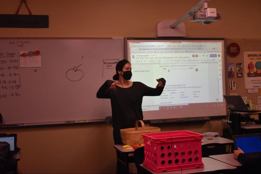 Foreign language teacher Blair Hopkins stands by the smart board while she teaches her Spanish One class about different food items. Though Hopkins began with teaching French, she now teaches both French and Spanish classes. “Self-pacing is the biggest thing Ive tried to take away [from the Excellent Fellowship program] because theres no class in the world where every single person needs exactly 10 minutes to do a task,” Hopkins said. “Im trying to learn more how to set it up so that everybody can work at their own pace.”