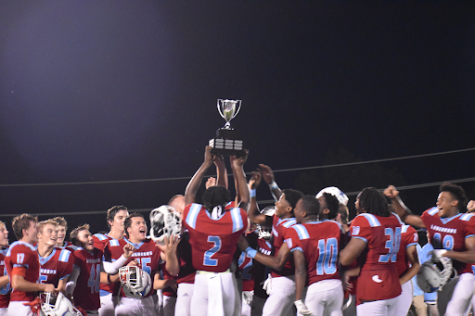 Varsity Football celebrates winning back the Mayors Cup. 