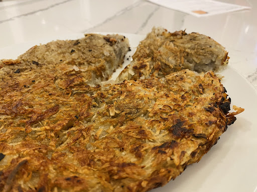 A piece of the Rösti we made, cut and ready to be served.