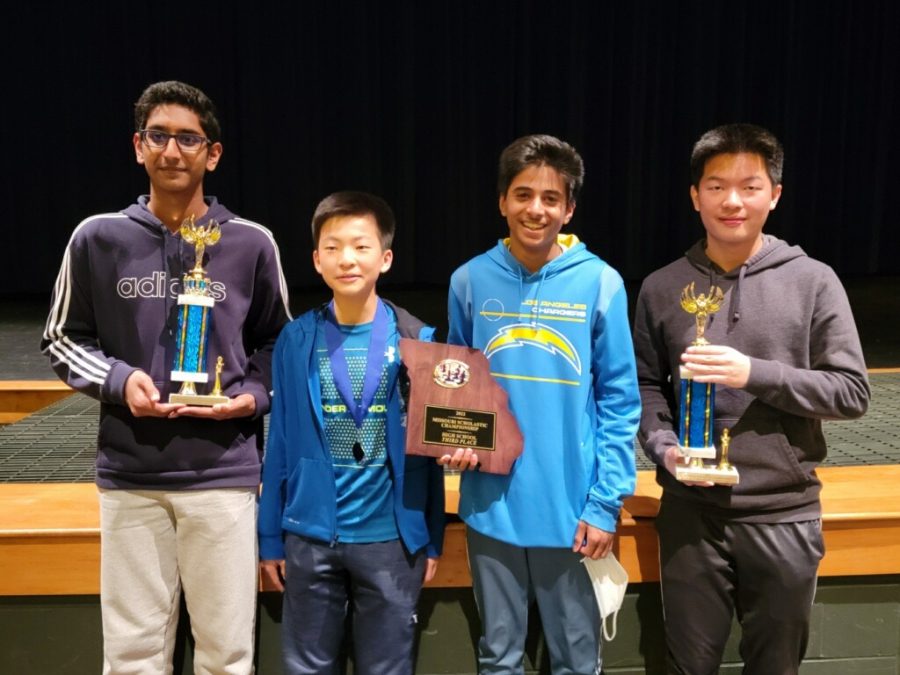 Holding+the+team+trophy%2C+members+of+the+Chess+Team+pose+for+a+photo.+The+team+finished+third+at+the+Missouri+State+Scholastic+Chess+Championship++at+Battle+High+School%2C+Columbia%2C+Mo.+The+tournament+was+held+in-person+for+the+first+time+in+three+years+due+to+the+COVID-19+pandemic.+%E2%80%9CIts+definitely+different+from+playing+chess+solo%2C+you+have+to+coordinate+with+each+other%2C+prep+each+other+up%2C+and+make+sure+that+we+all+perform+well+in+order+to+attain+a+trophy+position%2C%E2%80%9D+Chess+Team+captain+and+junior+Wilson+Gao+said.+%E2%80%9CWhile+the+effort+to+win+is+important%2C+the+more+important+thing+is+having+fun.%E2%80%9D