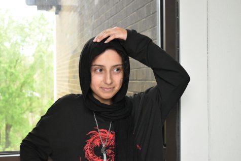 Sophomore Rand Al-Hachami poses for a picture at school, donning her hijab and Zulfiqar sword necklace. Even though Islamophobia is very present, Al-Hachami says she has met a lot of positive reactions concerning her decision to start wearing hijab. “[Hijab symbolizes] positive character traits that Islam promotes, like dependability and honesty,” Al-Hachami said. “Wearing it has made me feel closer to my Muslim friends as well as to my religion in general.”