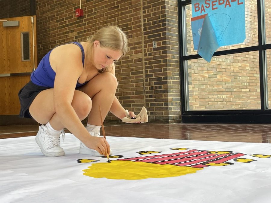 For two hours, seniors and varsity cheerleader Abigail Wheeler works on painting a poster for the homecoming football game entrance. The poster read ‘grab some popcorn: we’re about to put on a show’ and included all of the starting offense and defense players’ names. “My favorite part of cheering for the homecoming game was the student section,” Wheeler said. “Everyone comes to that game, so it’s even bigger than it usually is and everyone is super excited no matter if we win or lose, but hopefully we beat Lafayette.” 
