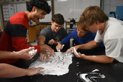 Laughing while studying, senior Ali Rehman writes in whipped cream for AP Environmental Science. Rehman wrote out the nitrogen cycle, the carbon cycle, and water cycle to help him prepare for his test. “I wanted to take this class because it seemed super interesting and appealed to my interests,” Rehman said. “This activity was really fun and helped me memorize the cycles for our test tomorrow.”