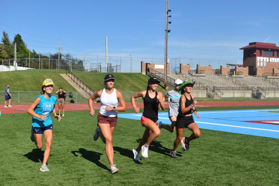 Striding across the turf, senior captain Lexi Etchason sports a hat for Fun Friday. To come up with theme ideas that made running more exciting, the captains took suggestions or searched TikTok trends. “Its a thing the coaches didn’t tell us to do and when someone forgot something, someone always had an extra. When you shared, you got to talk to that person. It brought us together because the more people who participated, the more fun it was,” Etchason said. “My favorite [Fun Friday theme] was the white lies. My sister and I had a really funny one, she and I both had The fastest Etchason on our shirts. It was fun because she and I got to make it together.”