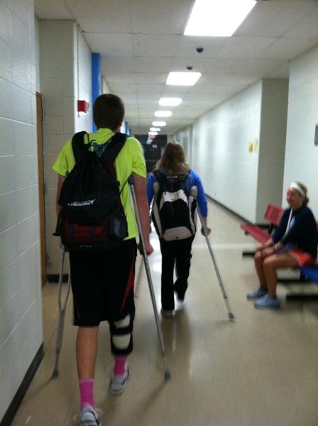 Seniors JC DeMuri and Amanda Anstine crutch their way to the gym class they cannot participate in. DeMuri received meniscus surgery while Anstine had ACL surgery.  My arms are going to get ripped from using the crutches all day long. I guess its worth the pain, Anstine said. 