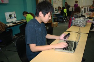 Bringing his own Mac to school, freshman Nick Chiu multitasks during class.  Chiu uses his own devise to take notes and work on class projects.  Its so much easier and faster to use my own equipment, Chiu said.