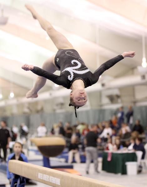 Senior Kelsey McClure performs on the beam at a gymnastics competition.  McClure practices year-round, and travels across the country for competitions.  “On my way to Indianapolis my family was driving in a snow and ice storm and we were forced to sleep in a car,” McClure said.

Photo Credit: Show-Me Photography
