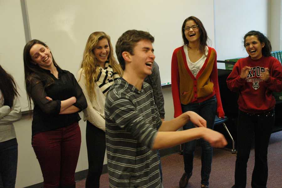 At improv club on Dec. 12, junior JD Lister takes part in the improv game ‘Jeopardy’ while juniors Annie Schuver, Yasmin Younis, Claire English and Rachel Rigden look on. Lister is also on the improv team, Running with Scissors.