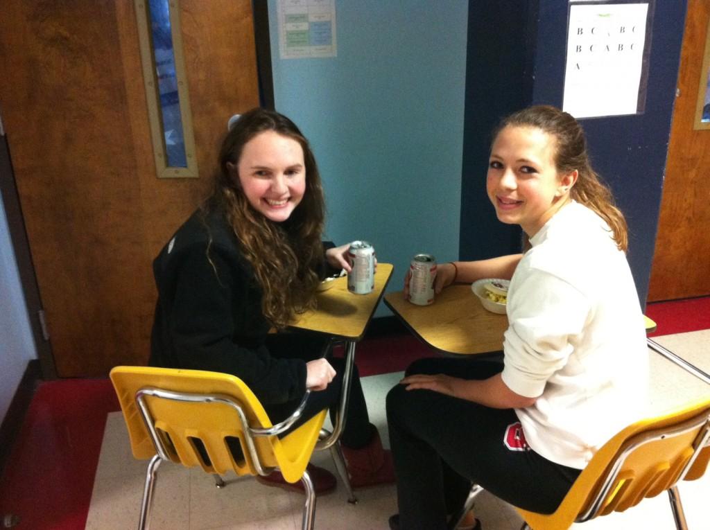 Juniors Rachel Brown and Gabby Rath sit outside of Jeff Chazens room after being kicked out of their fifth hour AP Government class for donating Easy Mac to Team Wayland. It was totally worth it because Wayland gave us good food and we still learned what we needed to know from the hall. I would do it again in a heartbeat, Brown said. 