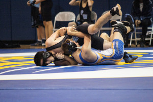 Senior Kyle Campell pins his opponent in his first match back after a strained AC joint.