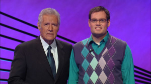 Filming his hometown howdy, math teacher Patrick Mooney stands next to Jeopardy host Alex Trebek. “Alex is great. He is really smart and funny and he even wants to get a picture with every single contestant,” Mooney said. 
