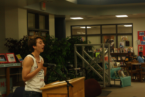 Senior Katherine Young performing her poem in front of a large audience. 