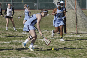 Senior Annie Spewak reaches for a ground ball while junior Kemone Lindo serves as backup.