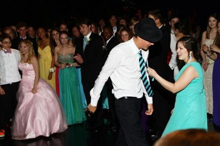 Junior Selah Mahaffey pulls her boyfriend Alex Tamang by his tie in their dance-off. The couple danced the entire night at Prom on April 27. The couple competed in small dance-offs against their peers. 