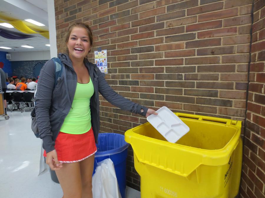 Senior Claire Logan throws away her tray in the compost bin. “I think it is really cool the way our school is helping out the environment. It’s not that hard to sort your trash,” Logan said. 
