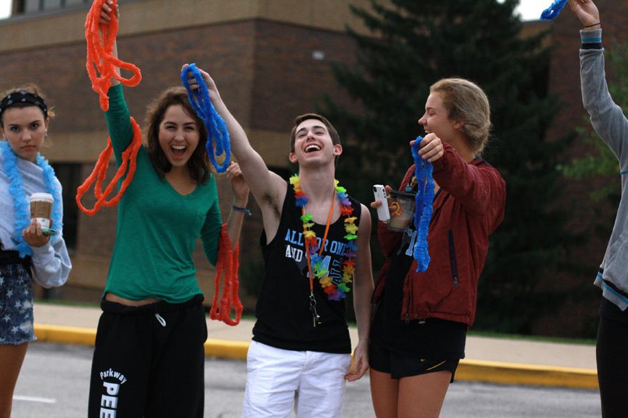 Standing in a line on the crosswalk, seniors Hillary Alden, Jason Erwin and Maddy Quoss cheer while throwing lei’s to the incoming freshmen on the first day of school. The Monday night before the first day of school, about 104 seniors camped out in the parking lot starting at 11pm. “Seeing all the freshmen react to the seniors cheering them on really made me feel old. I remember being a freshman and how terrified I was of high school, but seeing all the seniors clap for me made me feel right at home,” Erwin said. 